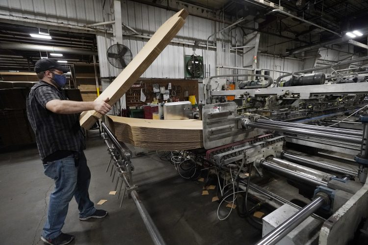 US jobless claims drop to 385,000, another pandemic low